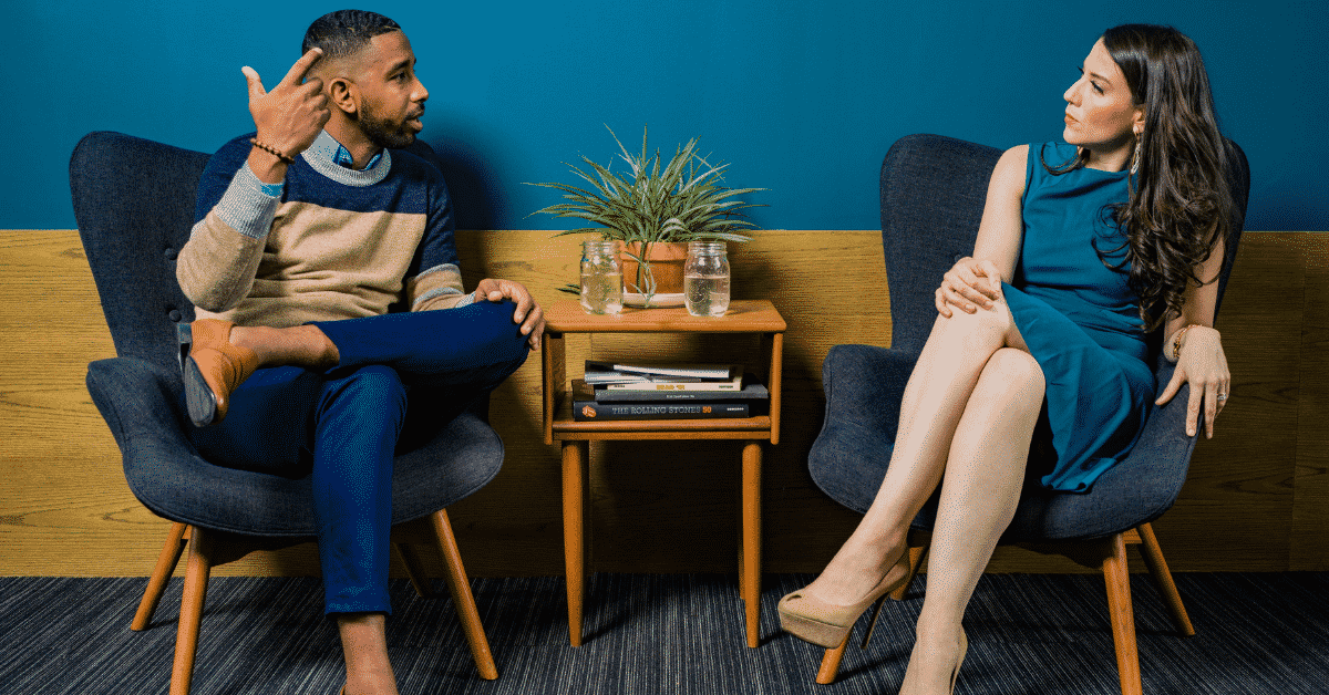 A buyer's agent their client having a seated conversation