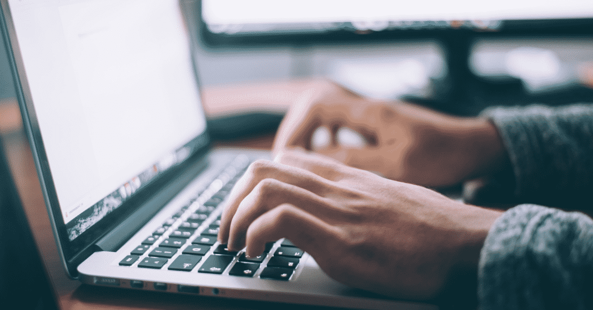 hands on laptop keyboard